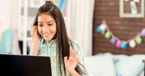 A student meeting with her peers in an online classroom experience.